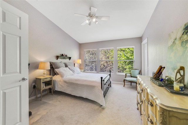 carpeted bedroom with ceiling fan and lofted ceiling