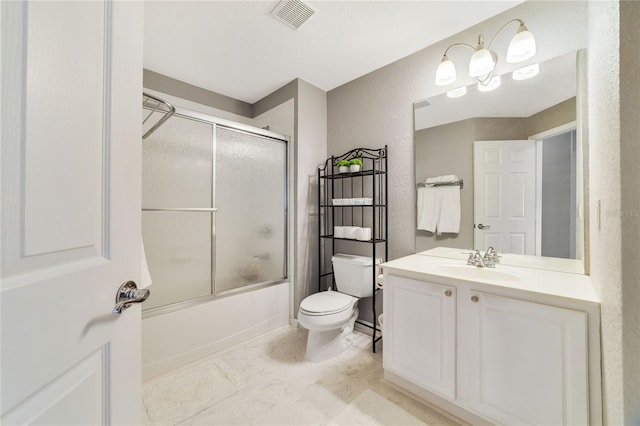 full bathroom with vanity, bath / shower combo with glass door, and toilet