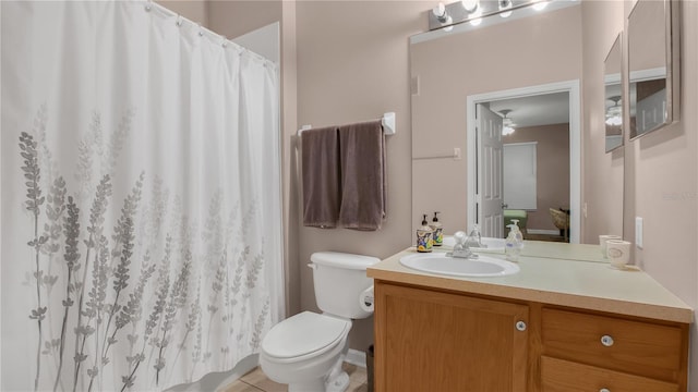 bathroom with tile patterned flooring, vanity, and toilet