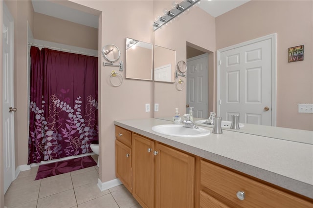 bathroom featuring tile patterned floors, vanity, and toilet