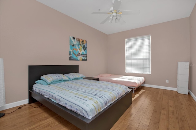 bedroom with light hardwood / wood-style floors and ceiling fan