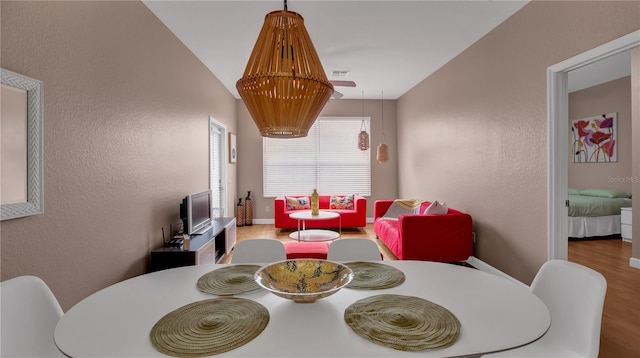 dining room featuring hardwood / wood-style floors and lofted ceiling