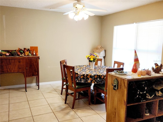 dining area with light tile patterned floors and ceiling fan