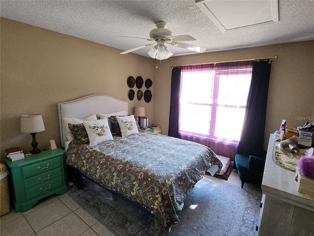 bedroom with light tile patterned floors, a textured ceiling, and ceiling fan