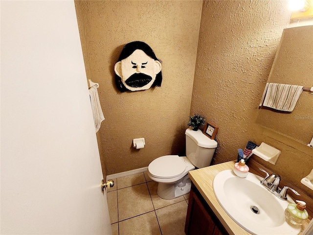 bathroom featuring toilet, vanity, and tile patterned floors