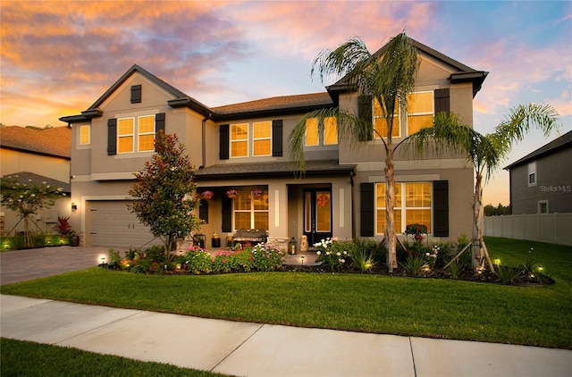 view of front facade featuring a garage and a yard