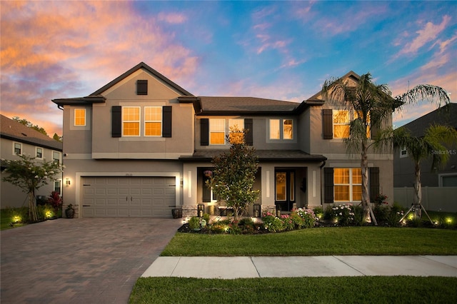 view of front of home featuring a lawn and a garage