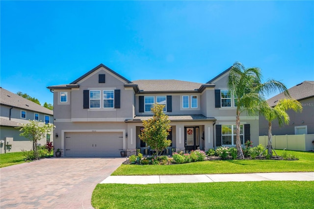 view of front of property with a front yard and a garage