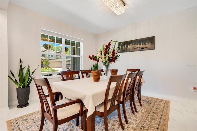 dining space with an inviting chandelier