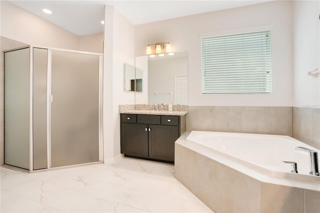 bathroom featuring separate shower and tub and vanity