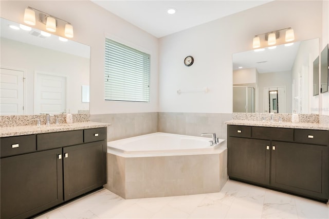 bathroom featuring vanity and shower with separate bathtub