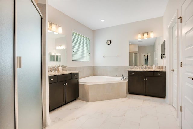 bathroom featuring vanity and shower with separate bathtub