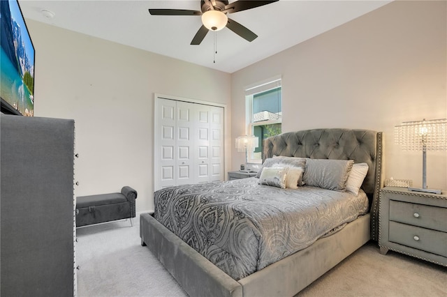 bedroom featuring light carpet, a closet, and ceiling fan