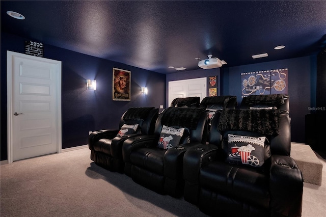 cinema room with carpet flooring and a textured ceiling