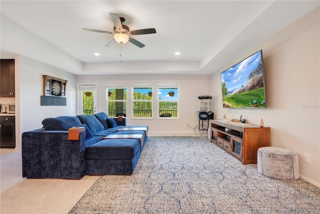 living room featuring light carpet, plenty of natural light, and ceiling fan