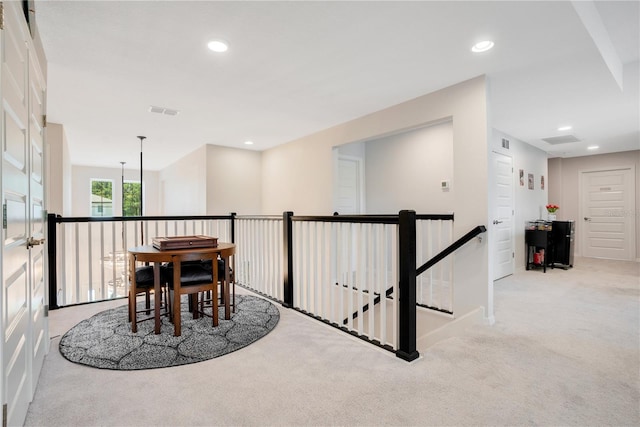 corridor featuring light colored carpet