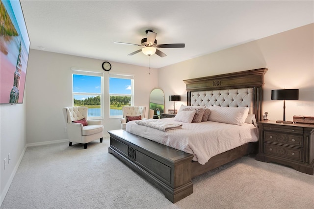 bedroom with ceiling fan and light carpet