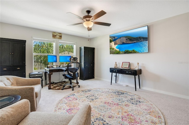 office space featuring light carpet and ceiling fan