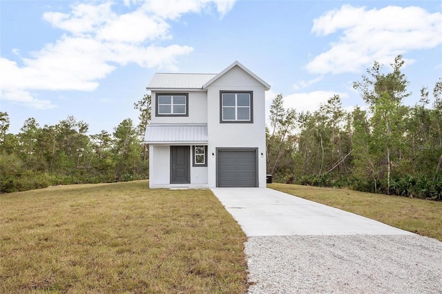 view of front of home with a front yard and a garage