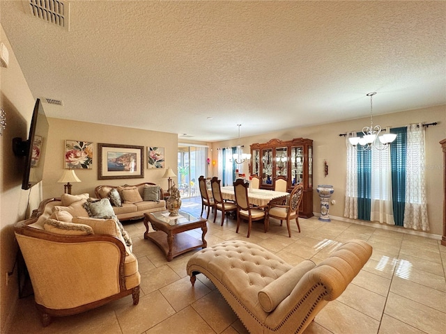 tiled living room with a textured ceiling and an inviting chandelier