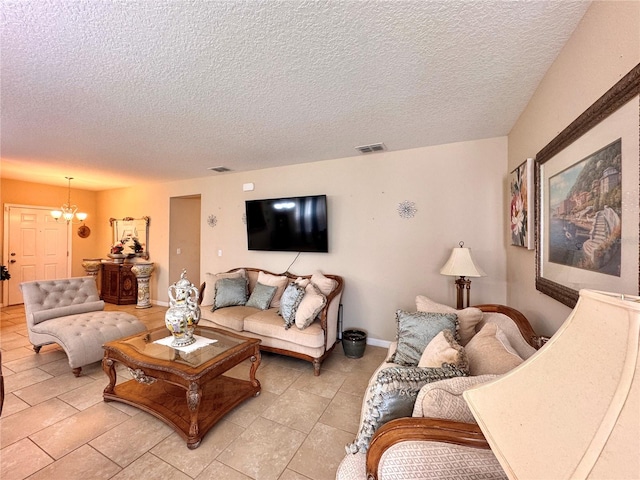 tiled living room with a textured ceiling and a notable chandelier