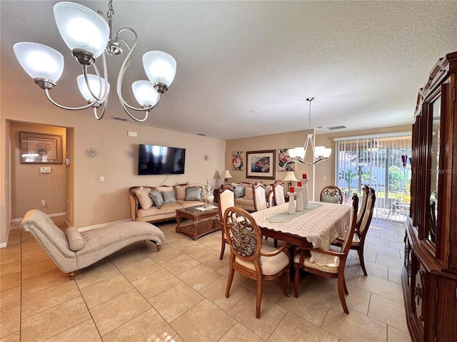 dining space featuring light tile patterned floors, a chandelier, and a textured ceiling