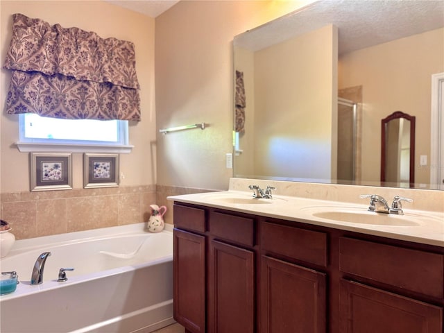 bathroom featuring vanity, a textured ceiling, and independent shower and bath