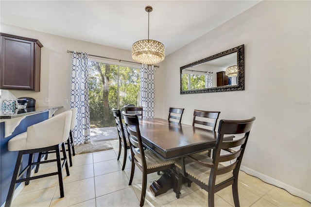 dining area featuring light tile patterned flooring and an inviting chandelier