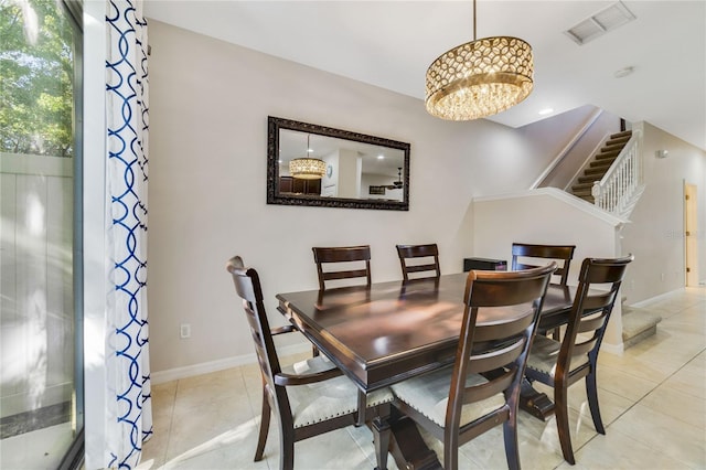 dining area featuring light tile patterned floors and a notable chandelier