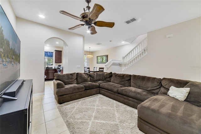 tiled living room with ceiling fan