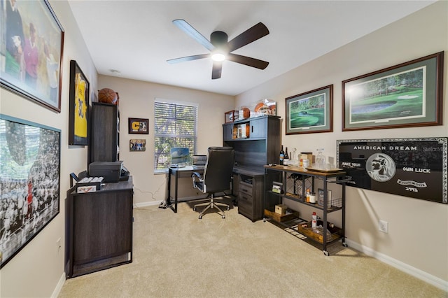 office space featuring light carpet and ceiling fan