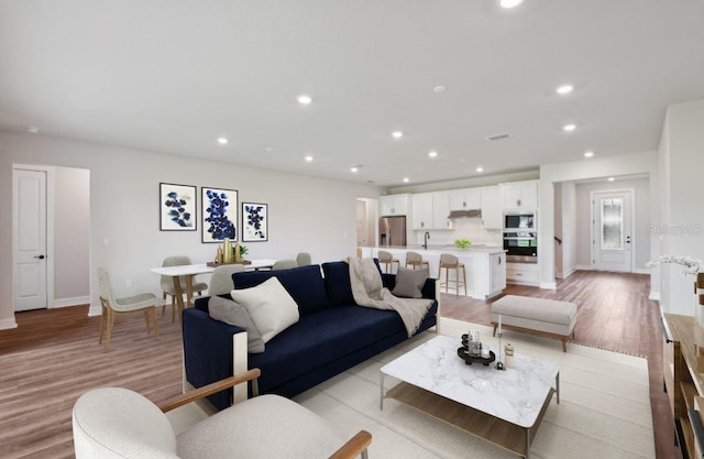 living room with light hardwood / wood-style flooring