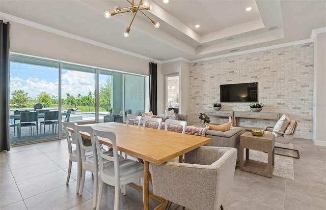 dining room featuring light tile patterned floors, ornamental molding, and a notable chandelier