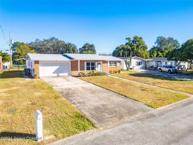 single story home featuring a garage and a front lawn