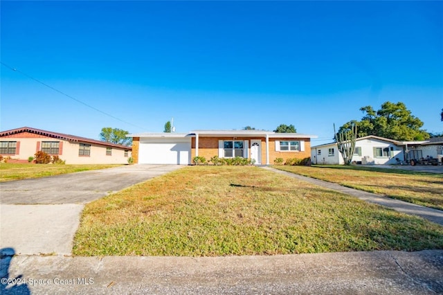 single story home with a front yard and a garage