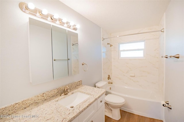 full bathroom with toilet, wood-type flooring, vanity, and tiled shower / bath combo