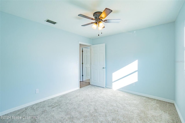 unfurnished room featuring light carpet and ceiling fan