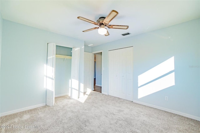 carpeted empty room with ceiling fan