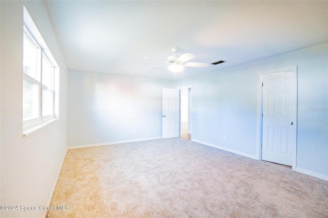 carpeted empty room with ceiling fan