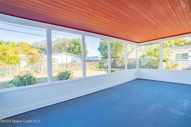 unfurnished sunroom with wooden ceiling and a healthy amount of sunlight