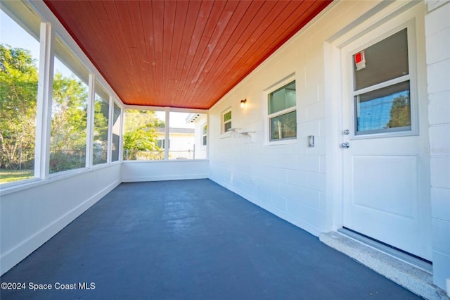 unfurnished sunroom with wooden ceiling