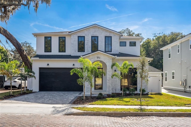 view of front of house featuring a front yard and a garage