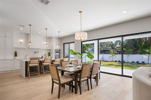 dining room featuring light hardwood / wood-style flooring and sink