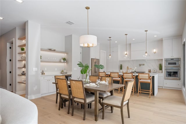 dining space featuring light wood-type flooring