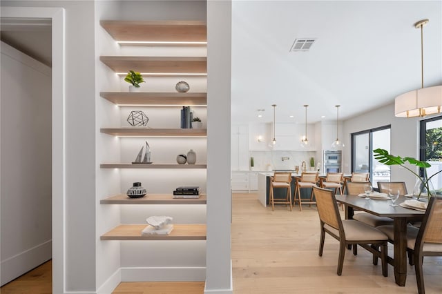 dining area featuring light wood-type flooring