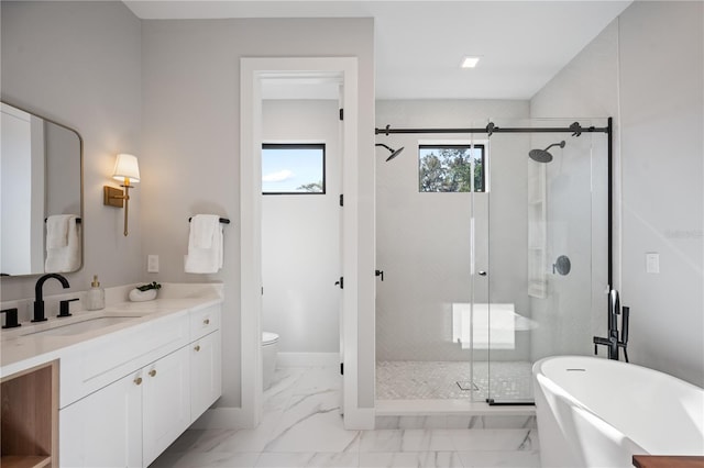 full bathroom featuring separate shower and tub, vanity, and toilet