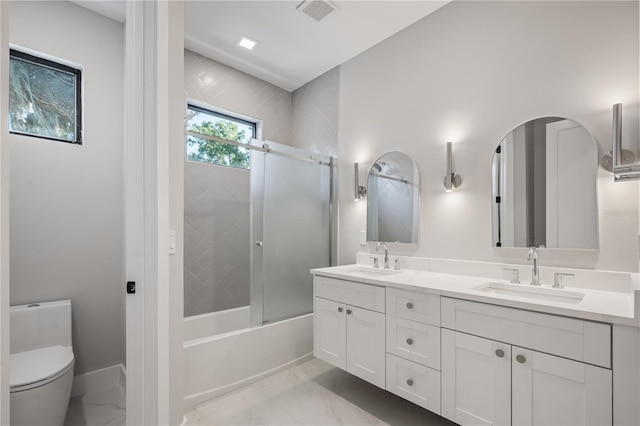 full bathroom featuring toilet, vanity, and combined bath / shower with glass door