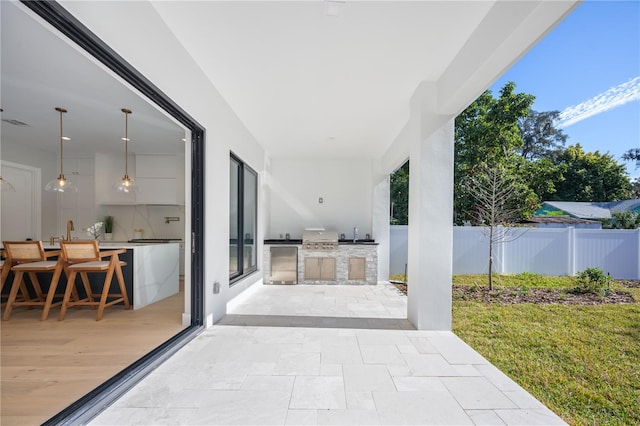 view of patio with area for grilling and exterior kitchen