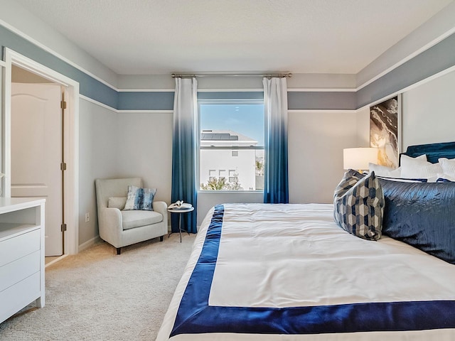 carpeted bedroom featuring a textured ceiling