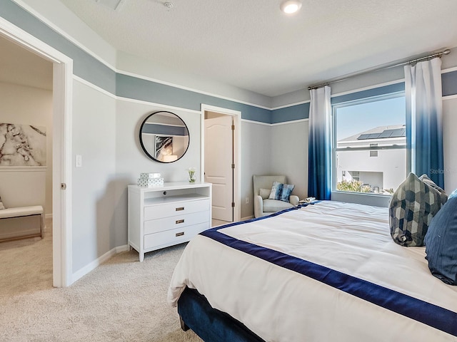 carpeted bedroom with a textured ceiling